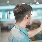 shallow focus photo of man in gray collared top taking selfie