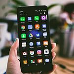 Selective Focus Photography of Person Holding Turned on Smartphone