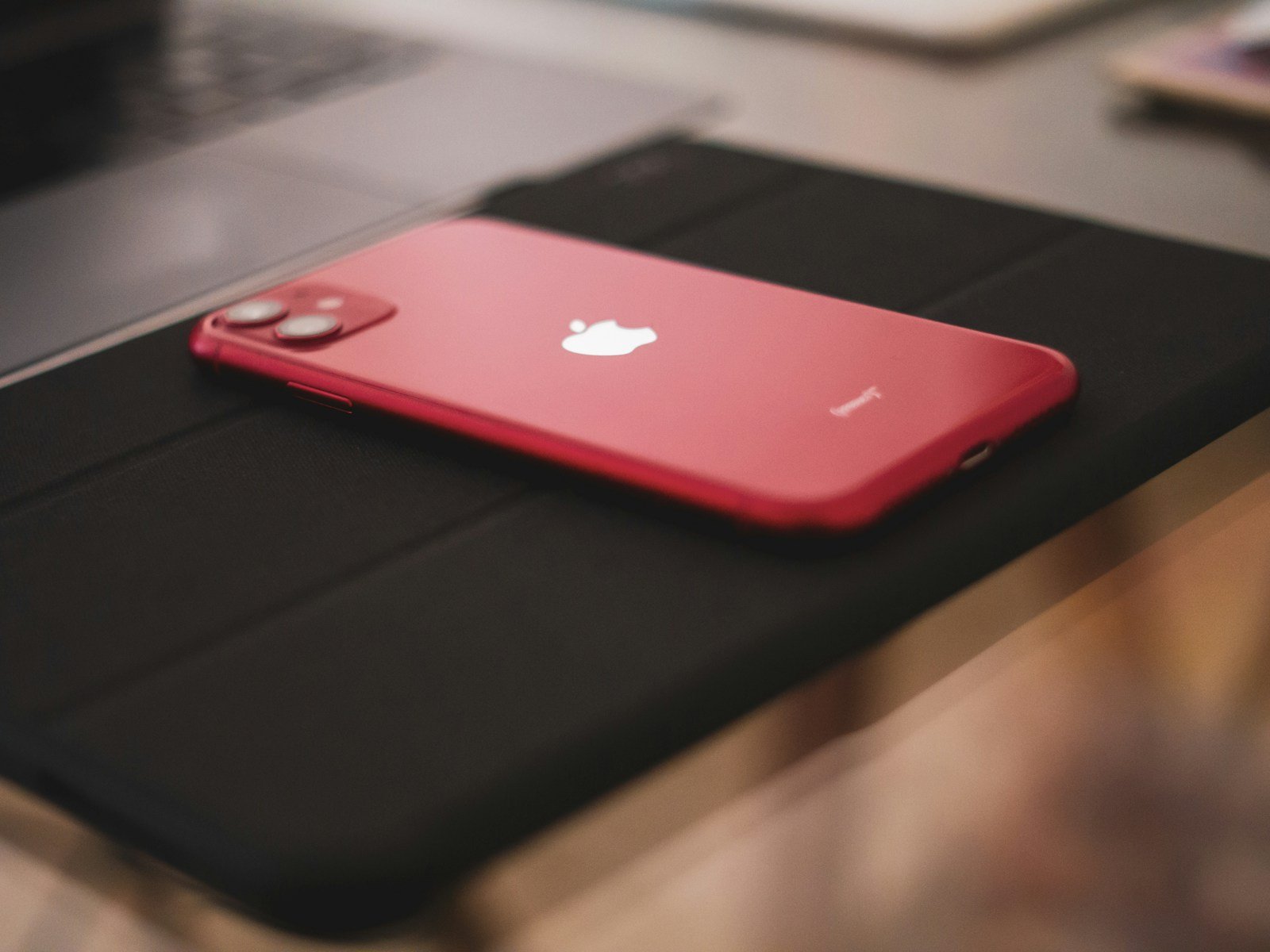 a red iphone sitting on top of a table