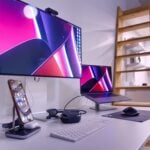 a desk with a laptop and a monitor on it