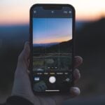 person holding iphone 6 taking photo of trees during sunset