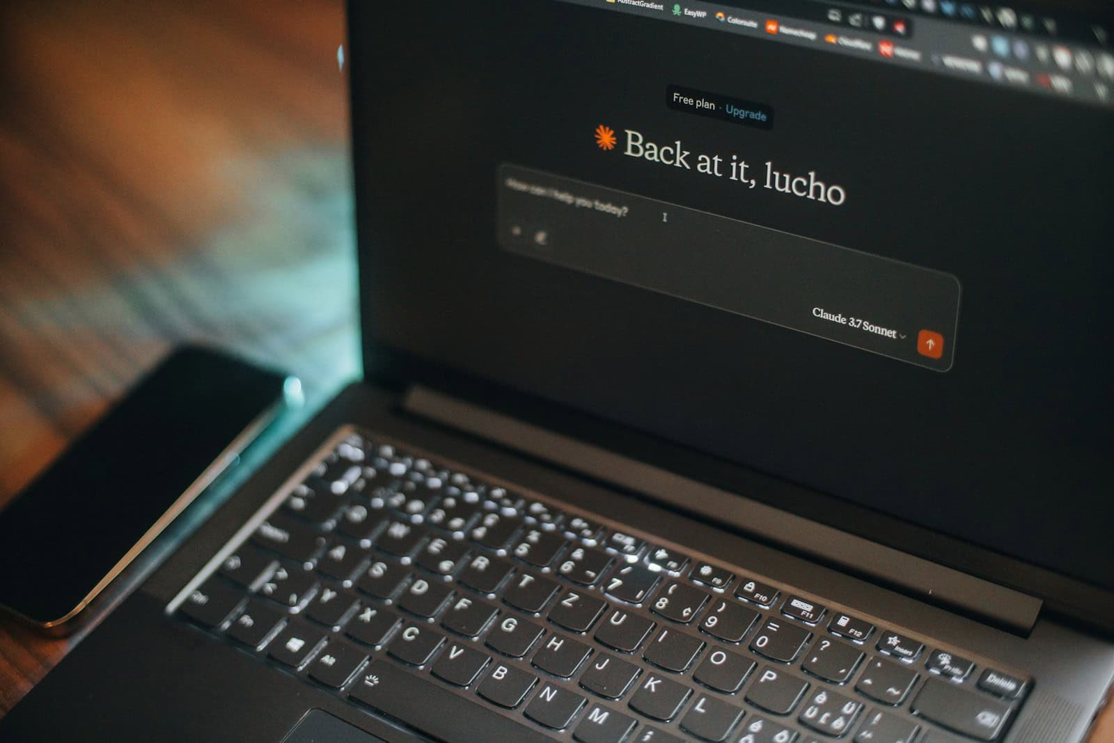 Laptop screen says "back at it, lucho".