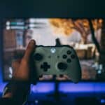 person holding white xbox one controller