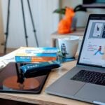 macbook pro beside white ceramic mug on brown wooden table