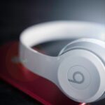 apple safari app icon closeup photo of white Beats by Dr. Dre wireless headphones