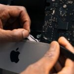 a man working on an apple computer