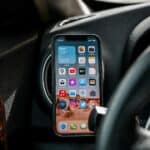 black iphone 4 on car dashboard