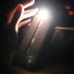 person holding black rectangular device