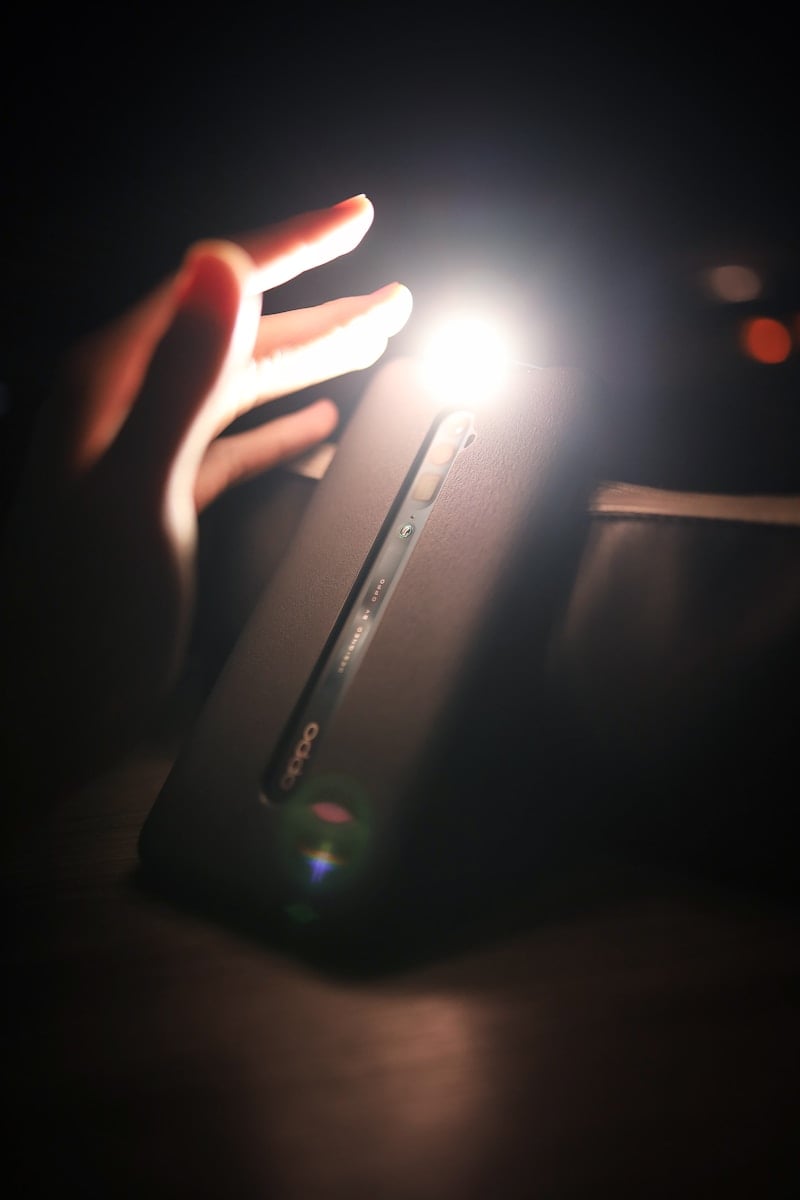 person holding black rectangular device