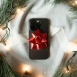 A cell phone with a red bow on it