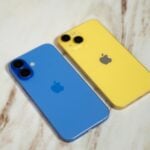 Two iphones sitting next to each other on a table