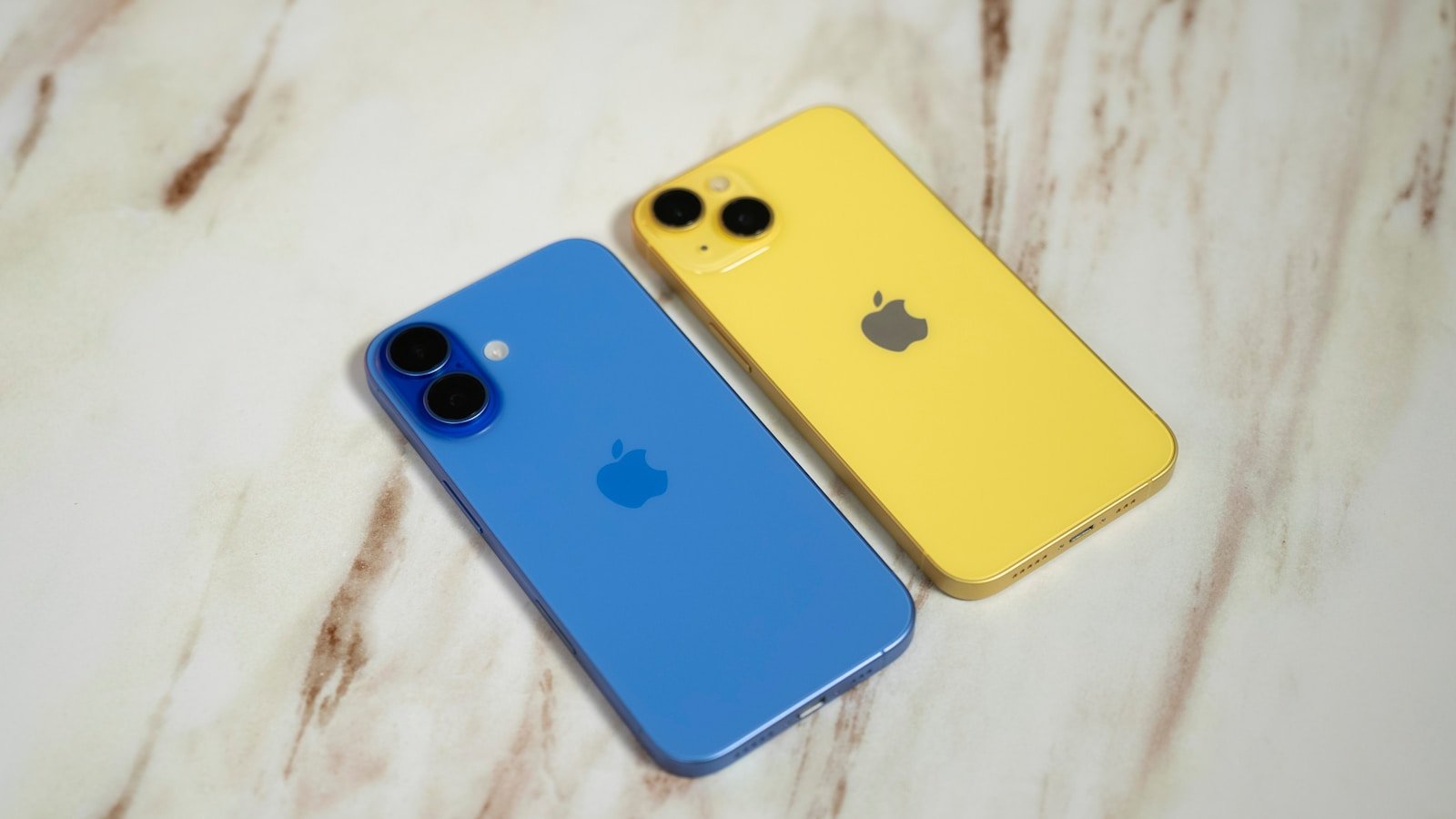 Two iphones sitting next to each other on a table