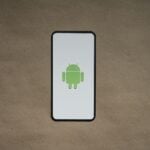 a cell phone with a green icon on it