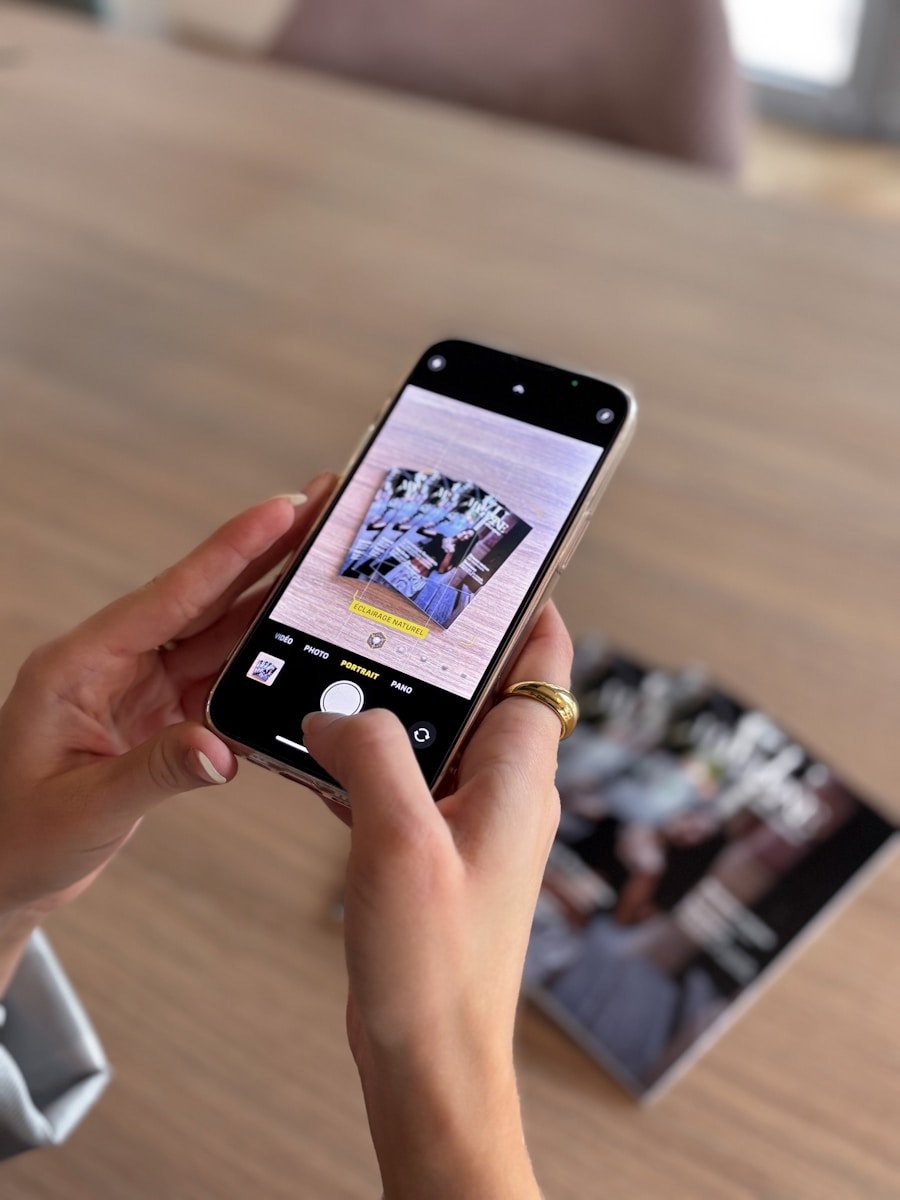 Hands holding phone taking picture of photos