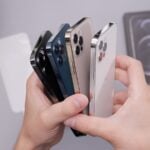 person holding white and black iphone case