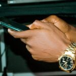 a close up of a person holding a cell phone