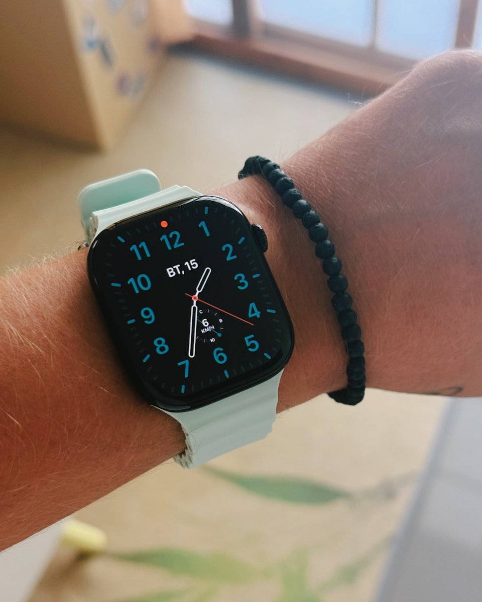 A person shows off their smartwatch and bracelet.