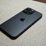 A dark gray smartphone with an apple logo.
