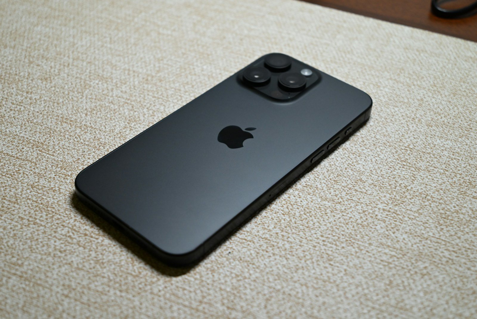 A dark gray smartphone with an apple logo.