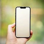 A person holding a cell phone in their hand