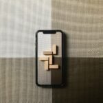 black iphone case on gray textile