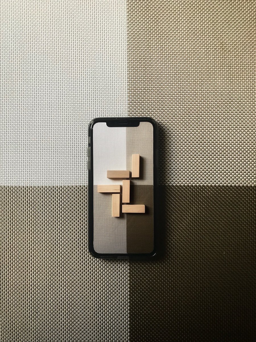 black iphone case on gray textile
