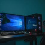 turned on desktop computer set with black and gray leather gaming chair