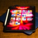 a tablet computer sitting on top of a wooden table