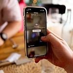 a person holding a cell phone in their hand