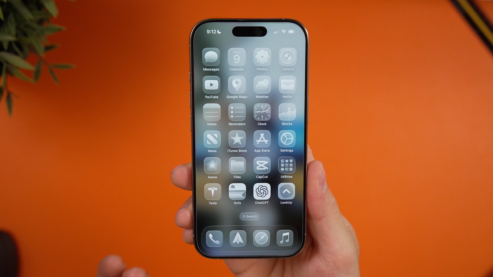 A person is holding an iPhone showcasing apps.
