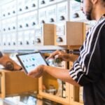 two men in a store looking at a tablet