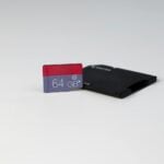 a black and red credit card sitting on top of a white table