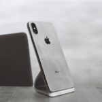 silver iPhone X on stand