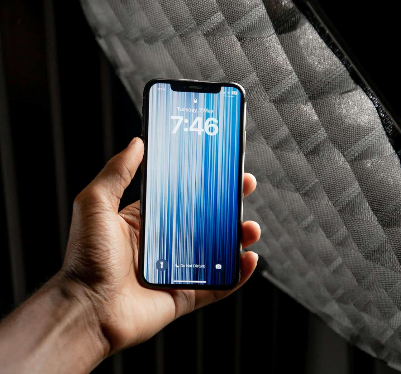 a person holding a cell phone in their hand