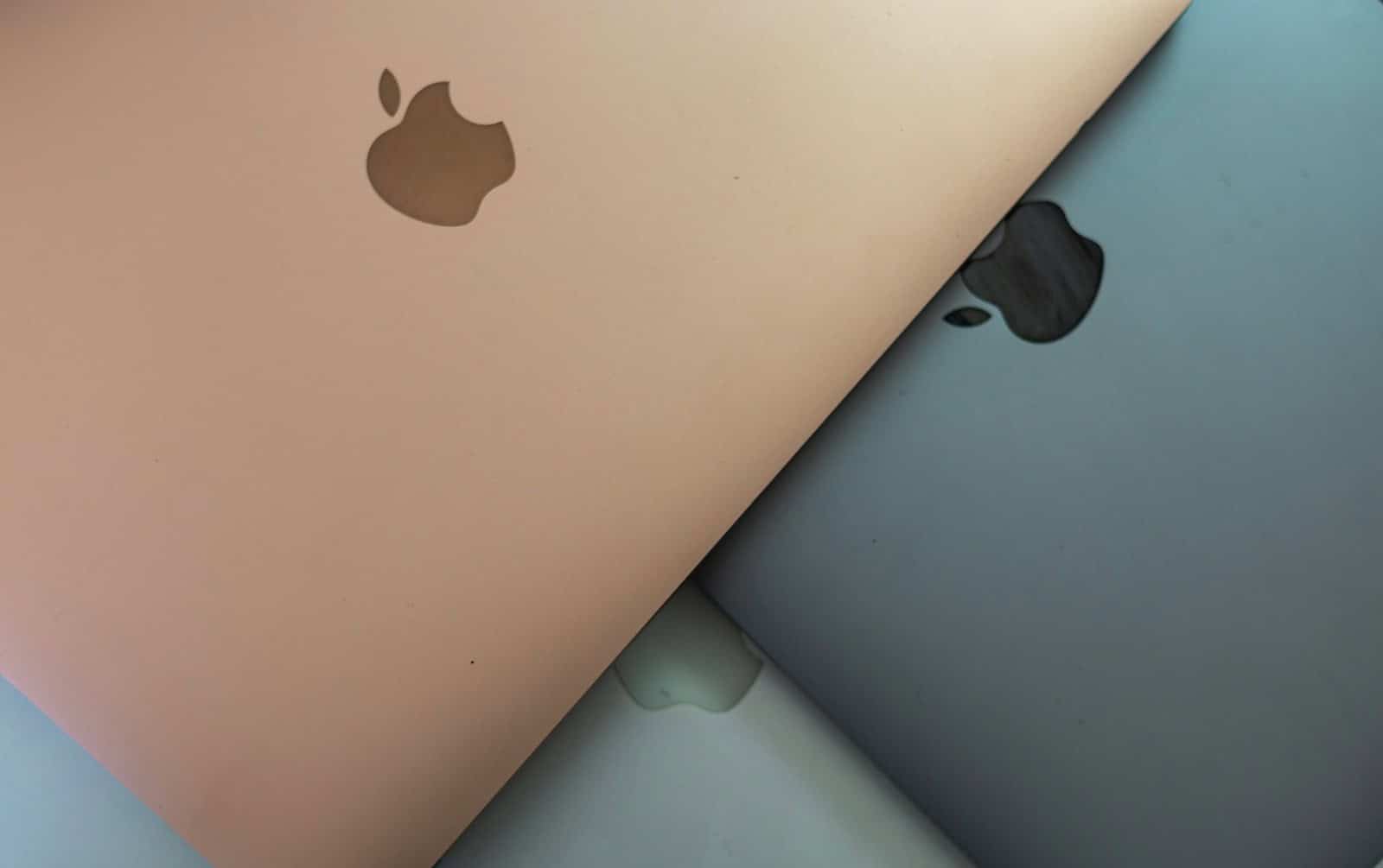 Apple laptops in different colors.