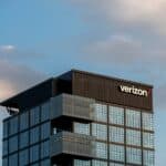 a very tall building with a verizon sign on top